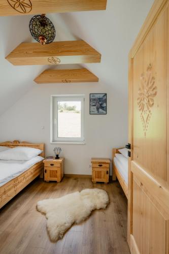 a bedroom with two beds and a window at Echo Gorców in Mszana Górna
