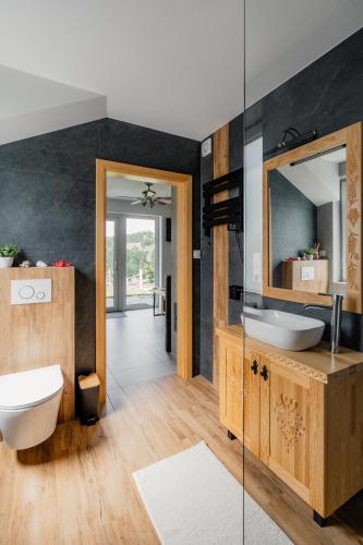 a bathroom with two sinks and a mirror at Echo Gorców in Mszana Górna