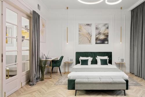 a white bedroom with a bed and a table at Downtown Bucharest Villa Private Garden & Garage for Parking in Bucharest