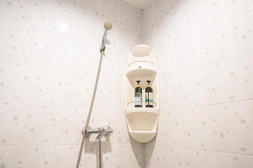 a toilet in a bathroom with a shower at The Houme - Fisherman Village in Bophut