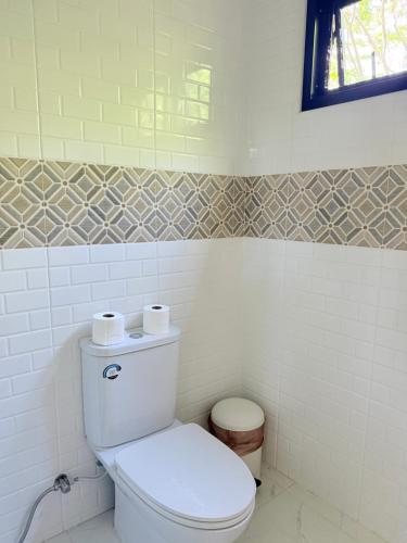 a bathroom with a toilet with two rolls of toilet paper at Alit House in Phra Nakhon Si Ayutthaya