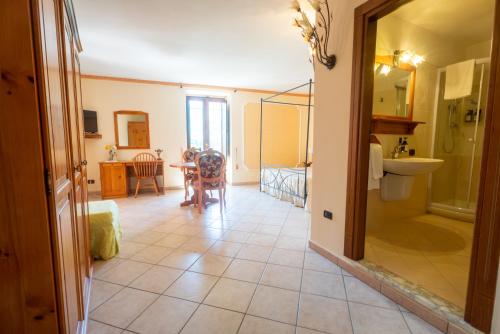 a bathroom with a sink and a table in a room at Filohostel l'Albergo Glocale in Sant'Agata de' Goti