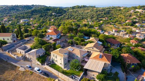an aerial view of a large house in a village at Dervisia Stonehouse 4 in Lazaráta