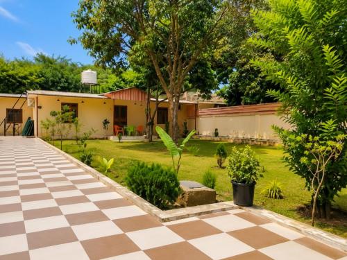 a garden with a checkered floor in front of a house at A2 Villa by JMD - Peaceful Stay Near Expo Mart in Greater Noida
