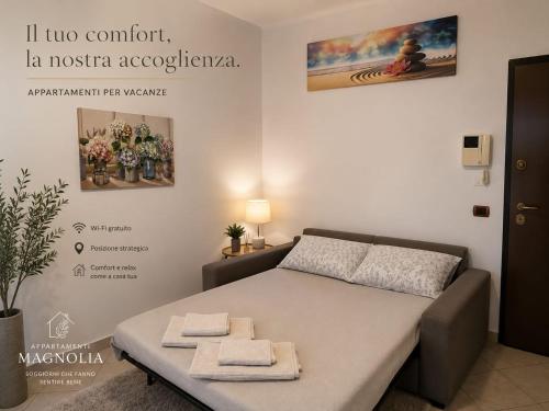 a bedroom with a bed with towels on it at Appartamento Magnolia 325 in Pomezia
