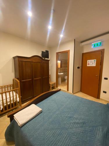 a bedroom with a large bed with a blue blanket at Masseria Frangiosa in Torrecuso