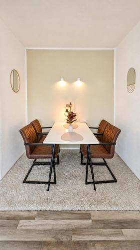 a dining room with a table and two chairs at Moderne liebevolle Ferienwohnung in Bergkamen