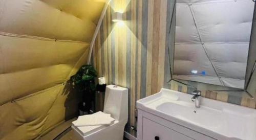 a bathroom with a white sink and a mirror at Stratus Resort in Khao Kho