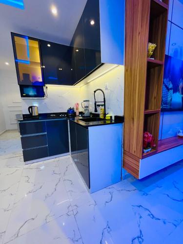 a kitchen with black and white marble floors and a sink at Flexxy Apartment Hotel in Oshogbo