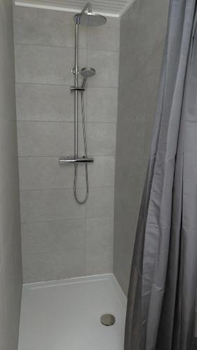 a bathroom with a shower with a shower curtain at B-SIDE Loppem in Zedelgem