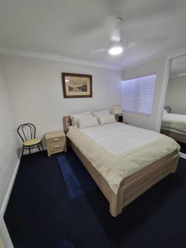 a bedroom with a large bed and a window at Avocet Apartment in Perth