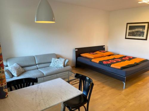 a living room with a couch and a bed at Kornblick in Korntal-Münchingen