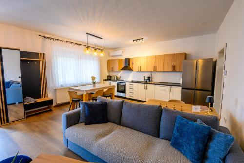 a living room with a couch and a kitchen at Apartment Mamma in Začretje