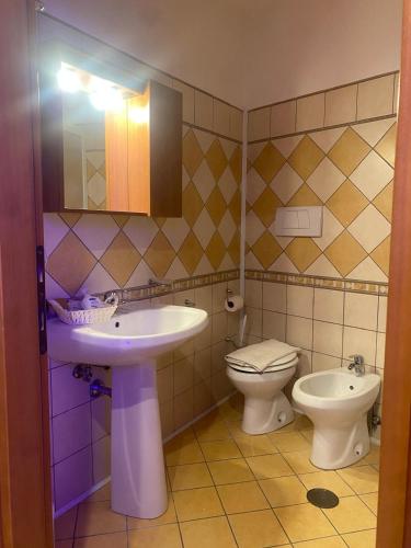 a bathroom with a sink and a toilet at Masseria Frangiosa in Torrecuso