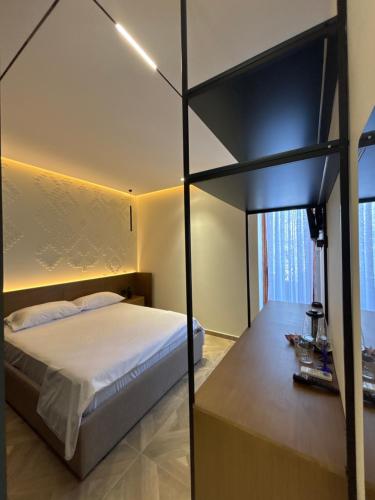 a bedroom with a bed with a black frame at Sulejmanasi Rooms in Vlorë