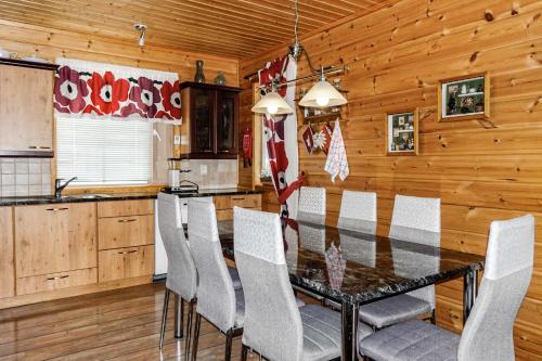 a dining room with a table and chairs at Orrenkolo, Lapland in Luosto
