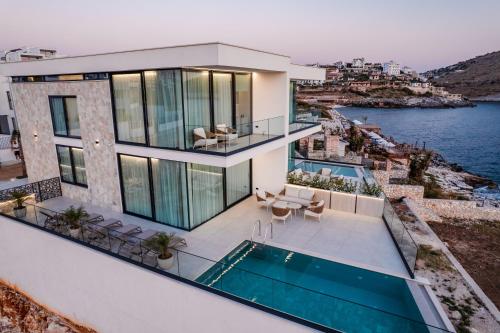 an aerial view of a house with a swimming pool at Nube Luxury Villas in Sarandë