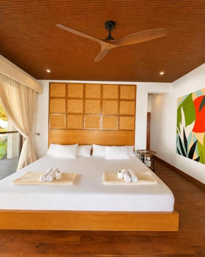 a bedroom with a bed with two towels on it at Sunset Villas Palauig Zambales in Palauig