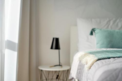 a bedroom with a bed and a lamp on a table at NOVERA Apartments #24 in Turčianske Teplice
