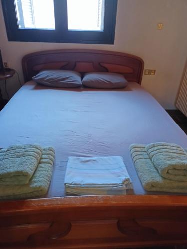 a bed with two pillows on it in a bedroom at Sea view Dilesi in Dhílesi
