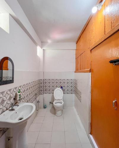 a bathroom with a toilet and a sink at Dawaipani Sona Homestay in Jālāpahār