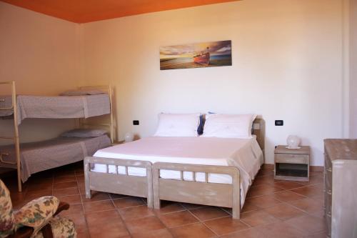 a bedroom with a bed and two bunk beds at Appartamento Mura in Forio d'Ischia