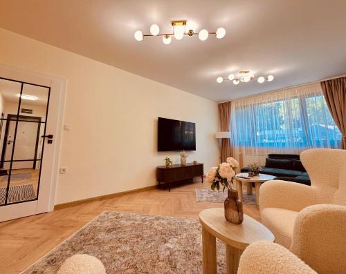 a living room with a couch and a tv at Central Apartment in Kyustendil