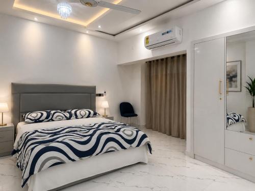 a bedroom with a black and white bed and a mirror at Kingdom homes in Amanfro