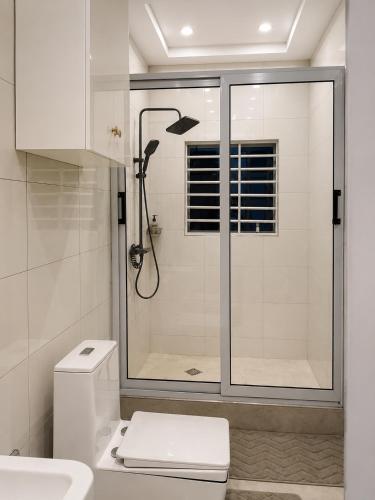 a white bathroom with a shower and a toilet at Kingdom homes in Amanfro