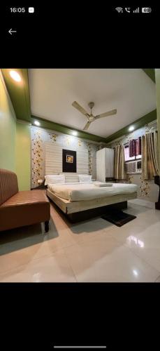 a large bedroom with a large bed and a couch at hotel darbar international in Gaya