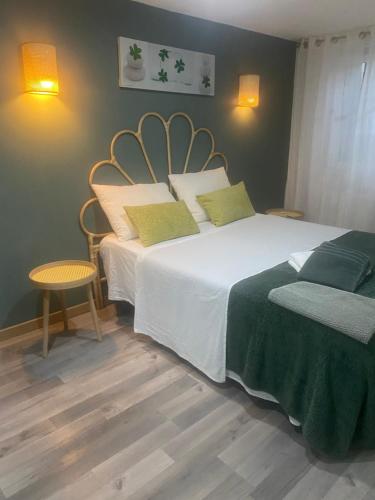 a bedroom with a large bed and a table and chairs at maison de village in Alairac
