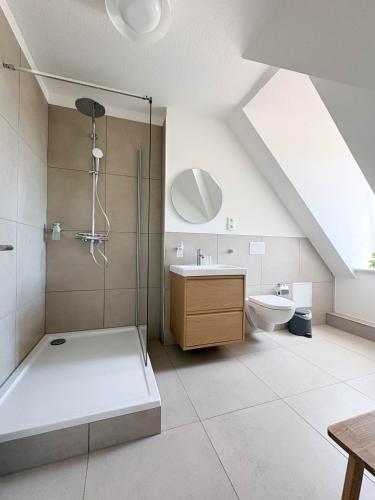 a bathroom with a shower and a sink and a toilet at Apartments am Alten Markt in Stralsund