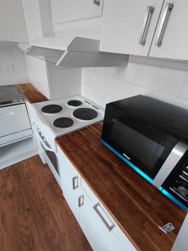 a kitchen with a microwave and a stove at Old appartment in Helsingborg