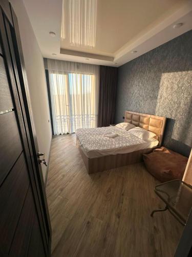 a bedroom with a bed and a large window at Millenium Villa in Kʼanakʼerravan