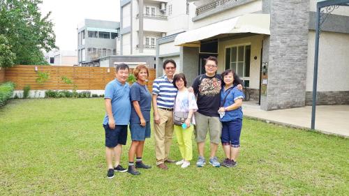a group of people standing in front of a house at Soar B&B in Taitung City