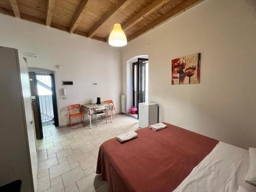 a bedroom with a bed and a table in a room at Corte Del Borgo Antico in Bari