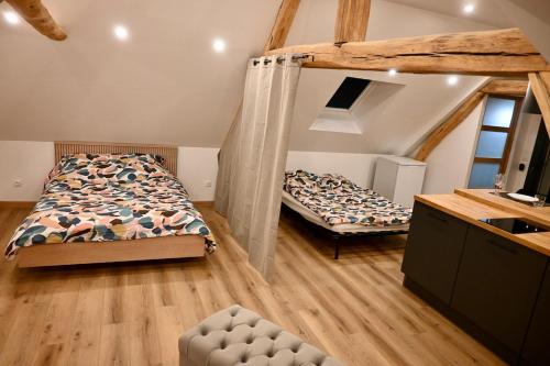 a bedroom with two beds in a room at Superbe Loft proche Troyes & Parking facile in Arcis-sur-Aube