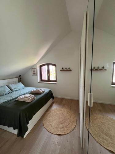 a bedroom with a bed and a window at Il Piccolo Aranceto in Motta SantʼAnastasia
