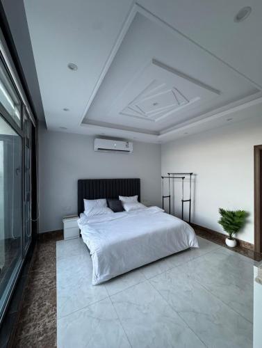 a bedroom with a large white bed and a ceiling at شاليه بيسان 1 in Jeddah
