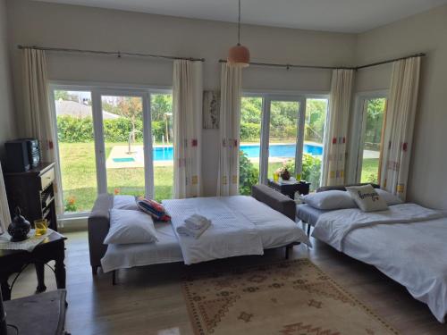 a bedroom with two beds and a view of a pool at Villa Piano in Gebze