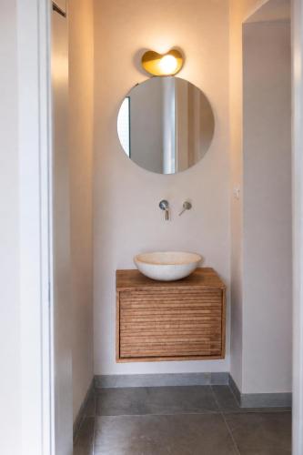 a bathroom with a sink and a mirror at Eterea Dimora Sul Fiume in Noto