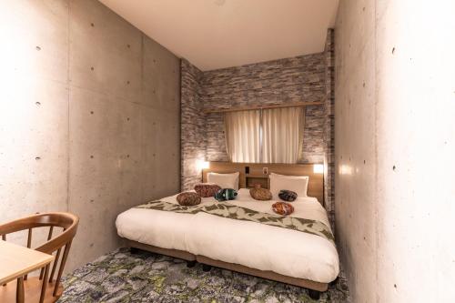 a bedroom with a large bed in a room at HALE Kyoto Tambaguchi ハレ京都丹波口 in Kyoto