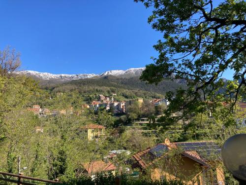 a town on a hill with mountains in the background at Hotel La Pineta in Cogoleto