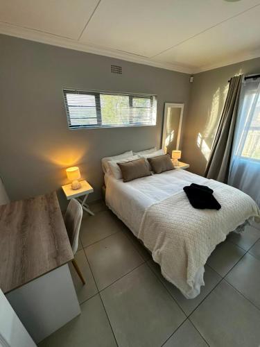 a bedroom with a large bed and a window at Klein Escape in Wilderness