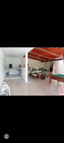a living room with a pool table and tables at Chácara silva in Nova Serrana