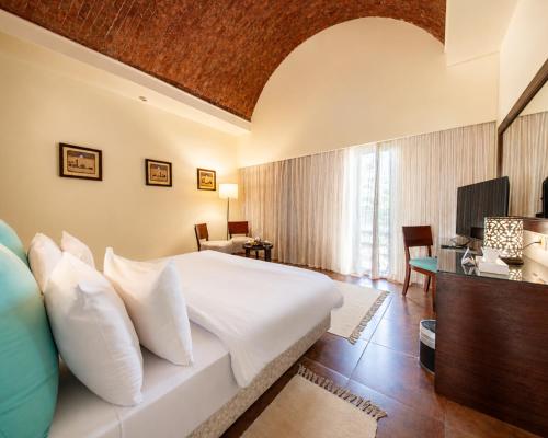 a bedroom with a large bed and a living room at Gemma Resort in Marsa Alam City