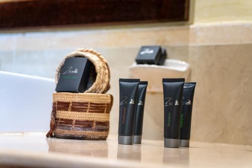 a bathroom counter with a basket and two batteries at Gemma Resort in Marsa Alam City