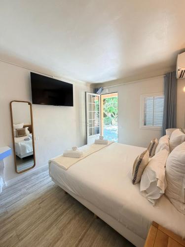 a large bedroom with a large bed and a window at Lou Cagnard in Saint-Tropez