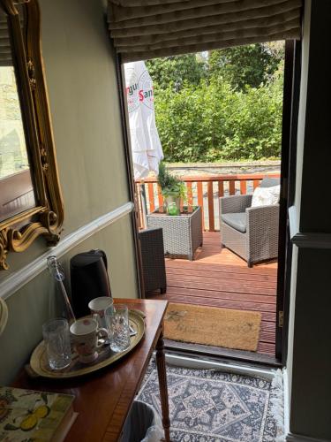 a room with a table and a wooden deck at Burford Lodge - Adults only in Burford