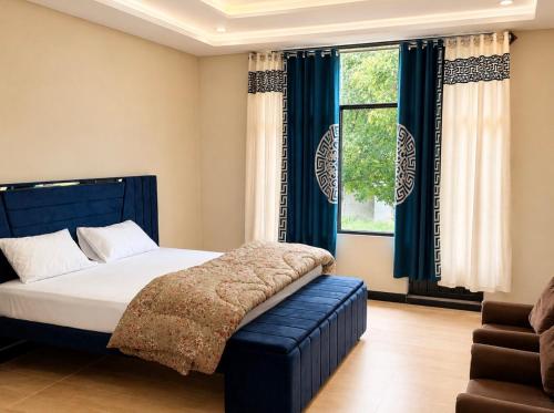 a bedroom with a bed and a window at Kove Hotel & Resort in Naran
